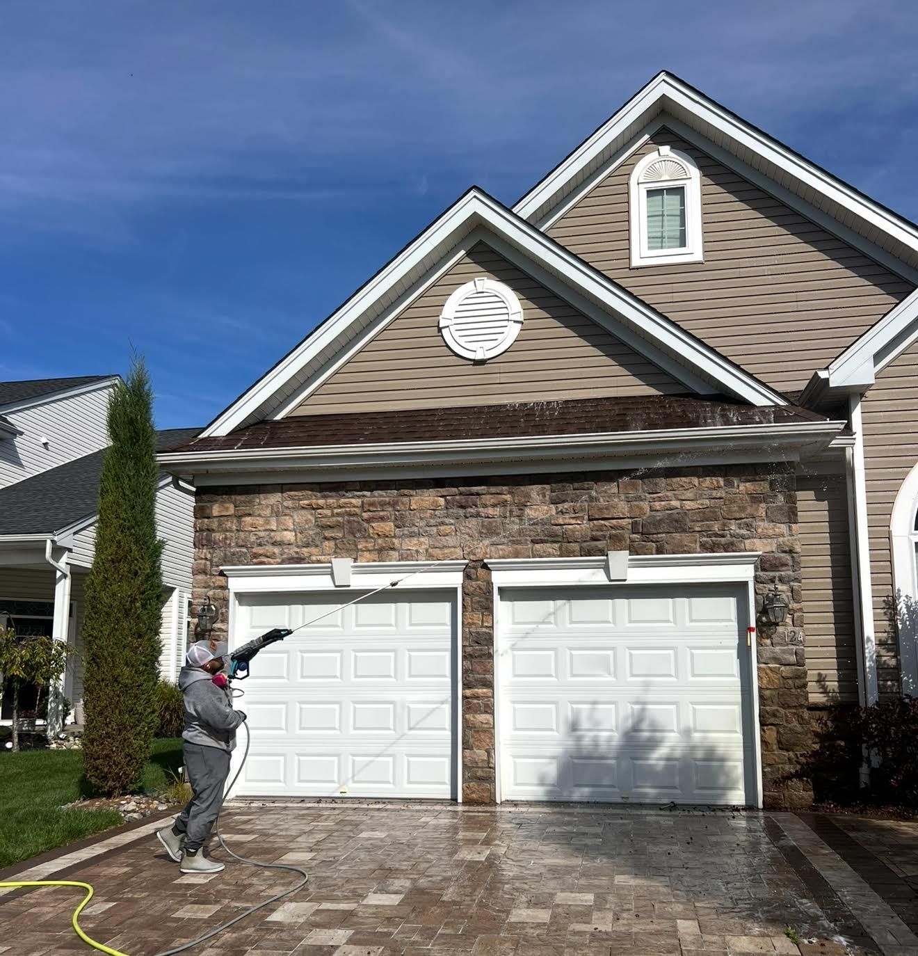 Catanzaro’s Power Washing team cleaning the exterior of a house