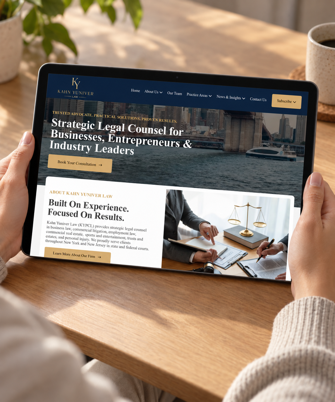 KYPCL website displayed on a handheld tablet