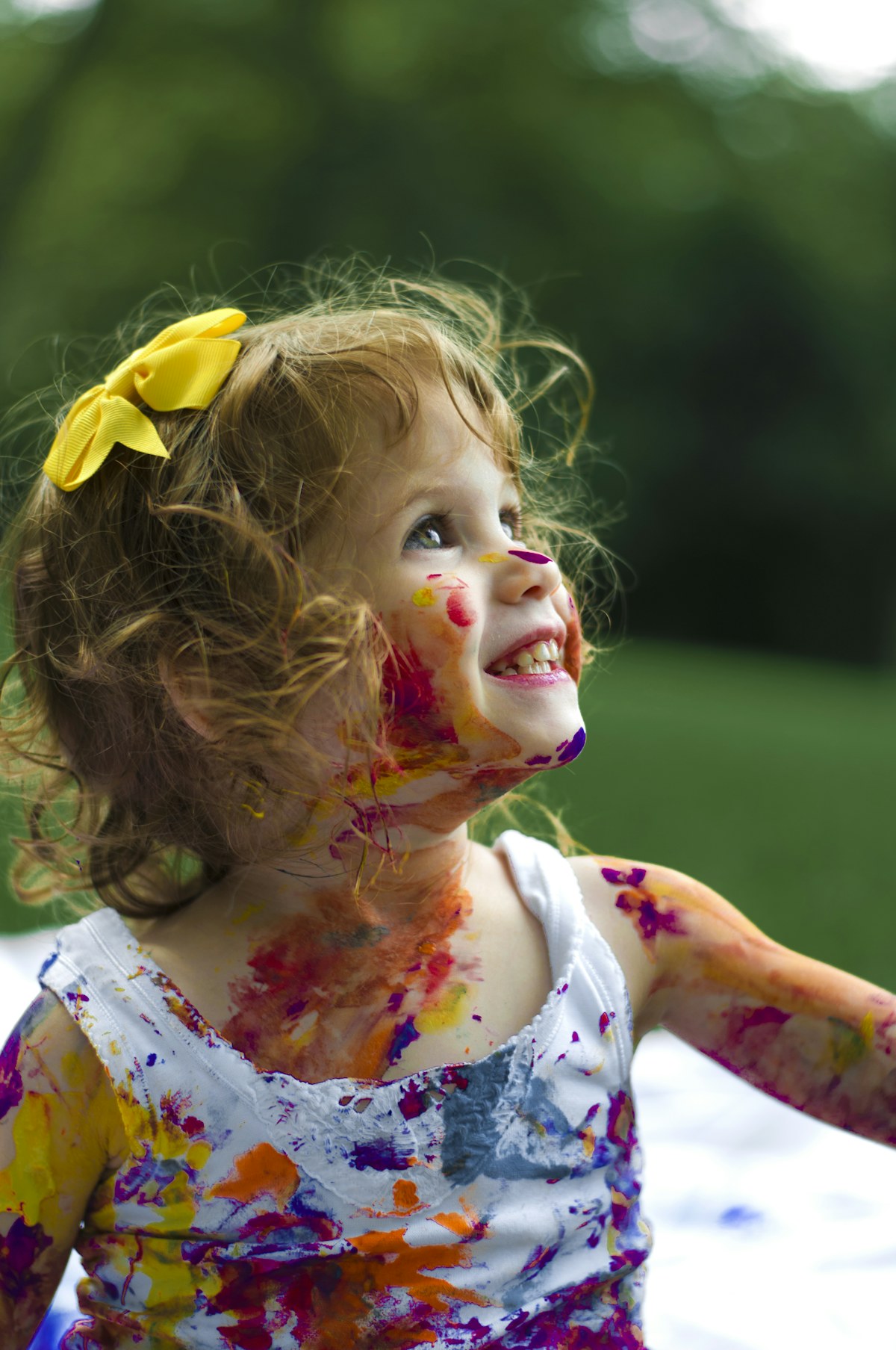 Young girl with colorful face paint at daycare