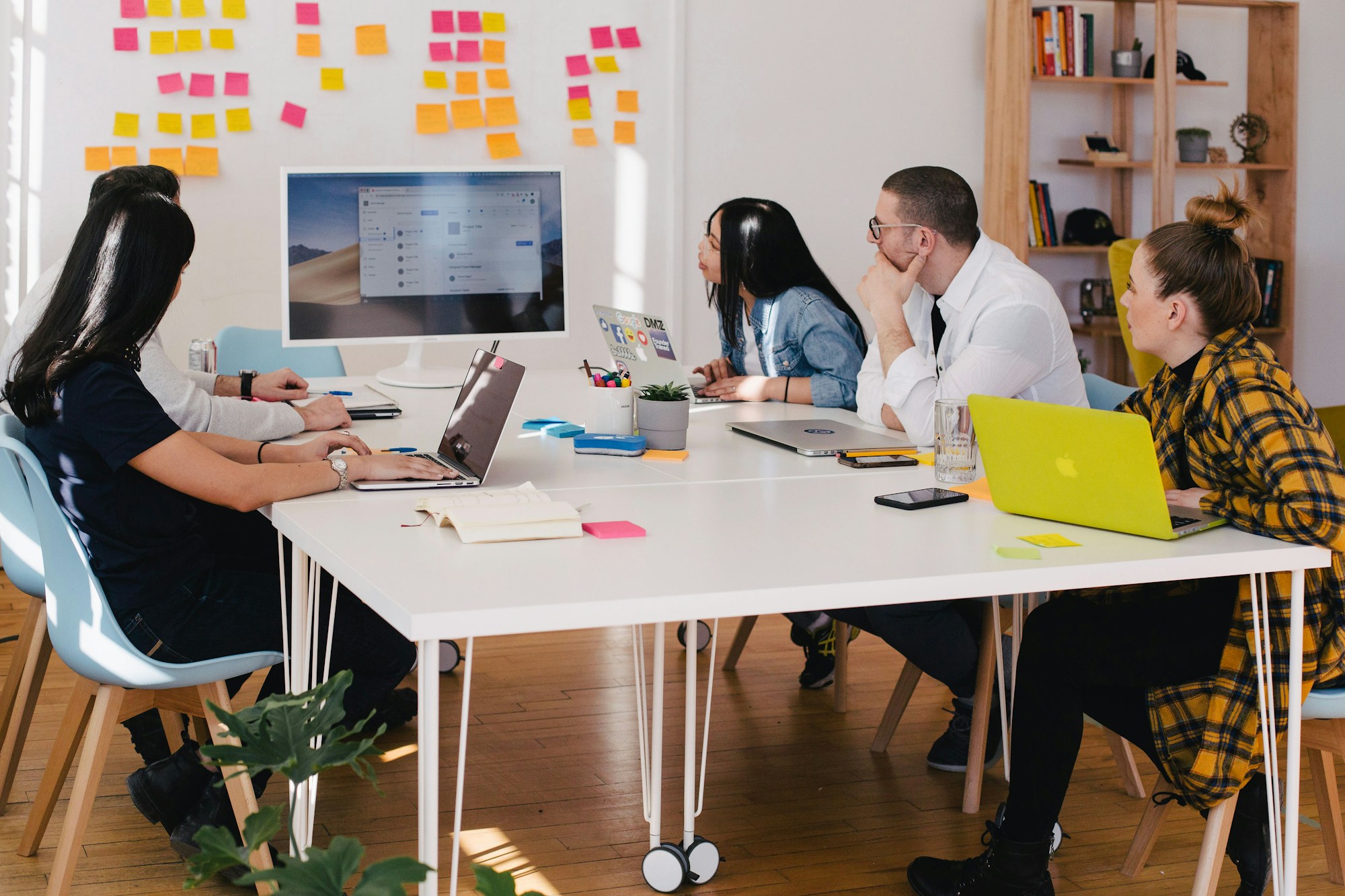 A marketing team planning campaigns with notes and screens