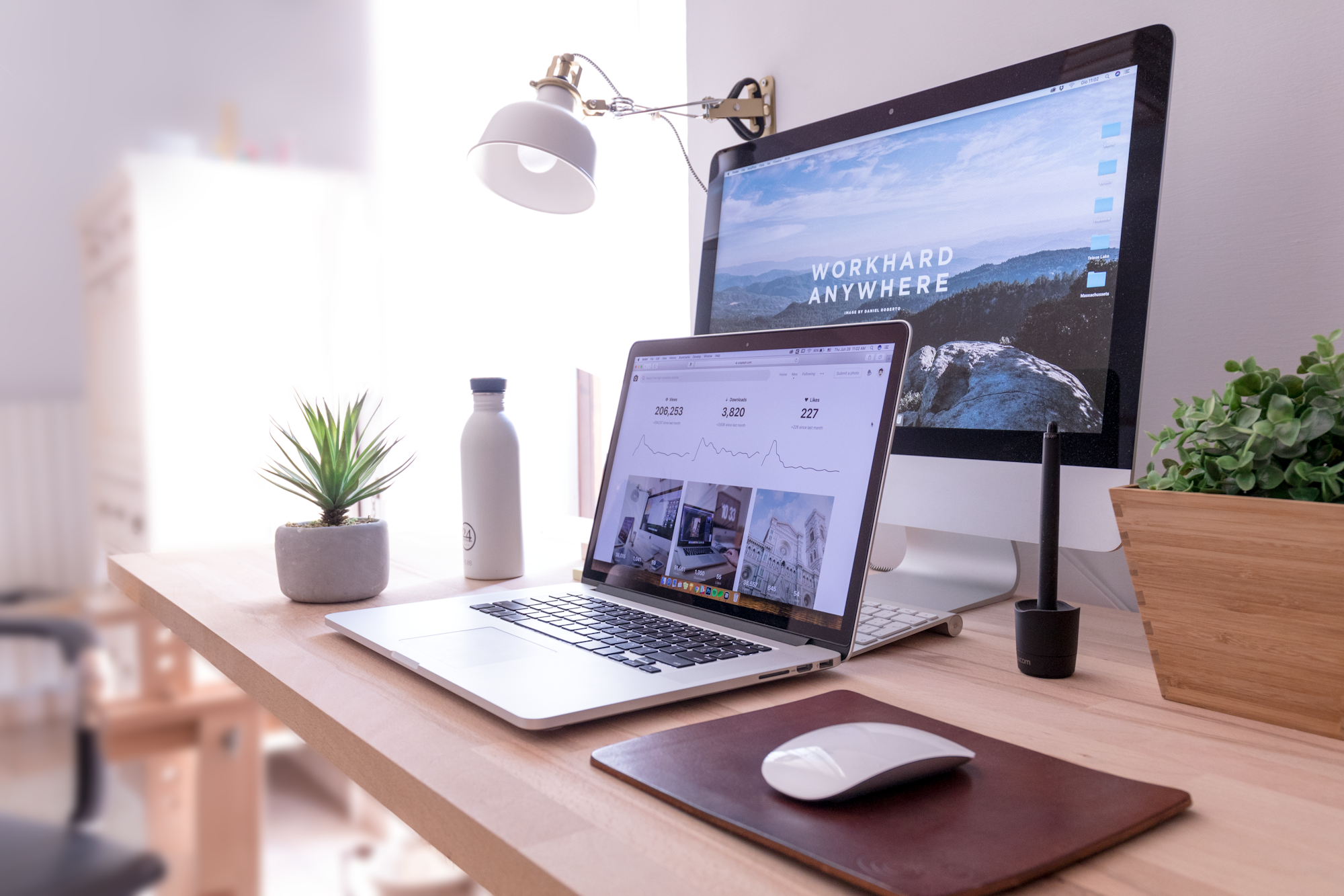 A website displayed across a laptop and desktop monitor
